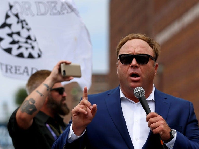 FILE PHOTO: Alex Jones from Infowars.com speaks during a rally in support of Republican presidential candidate Donald Trump near the Republican National Convention in Cleveland, Ohio, U.S., July 18, 2016.  REUTERS/Lucas Jackson/File Photo