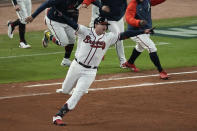Atlanta Braves' Austin Riley celebrates after hitting the game winning RBI single to score Atlanta Braves' Ozzie Albies in the ninth inning in Game 1 of baseball's National League Championship Series against the Los Angeles Dodgers Saturday, Oct. 16, 2021, in Atlanta. The Braves defeated the Dodgers 3-2 to take game 1. (AP Photo/John Bazemore)