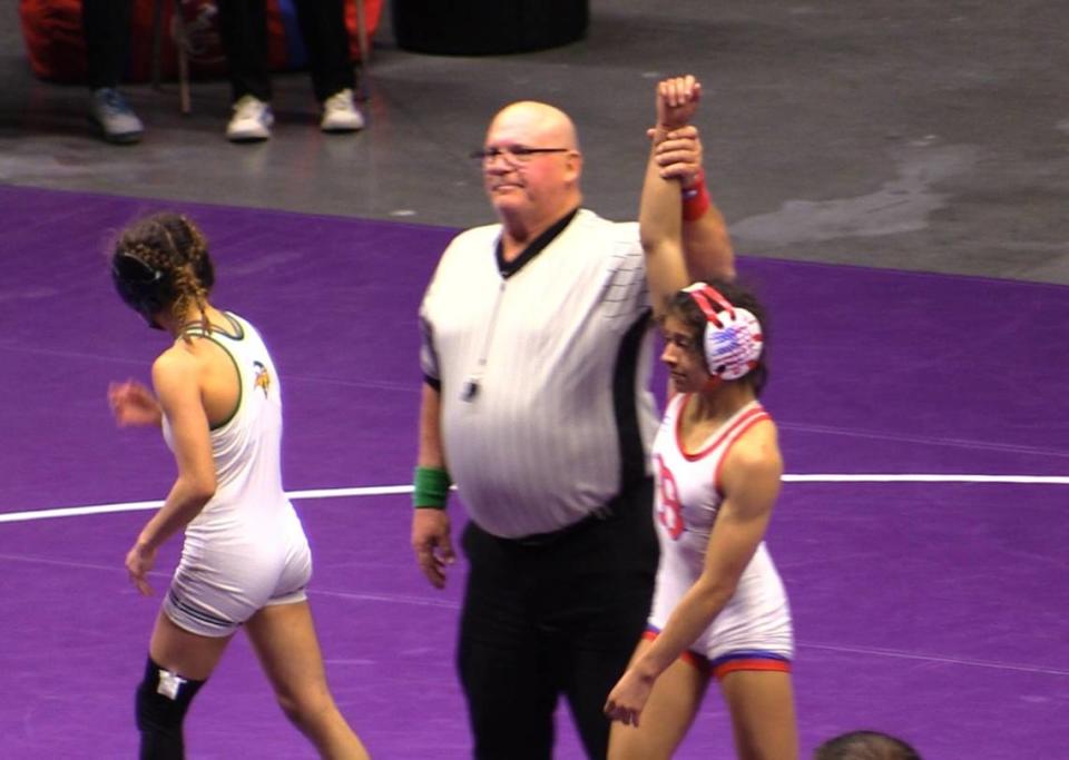 Christina Estrada of Buchanan gets her hands raised after defeating Josei Benitez of Kingsburg in 102 pounds at the Central Section Masters at Selland Arena in Fresno, California on Saturday, Feb. 17, 2024.