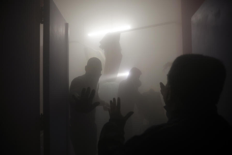 Palestinian paramedics inspect damage in the patient rooms caused by the Israeli strikes on the maternity ward at Nasser Hospital in the town of Khan Younis, southern Gaza Strip, Sunday, Dec. 17, 2023. (AP Photo/Mohammed Dahman)