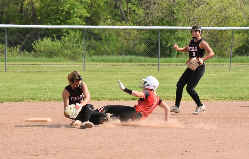 Clinton's Ava Ormsby slides into second base with a steal while Hudson's Dinah Horwath fields the throw during a doubleheader in the 2023 season.