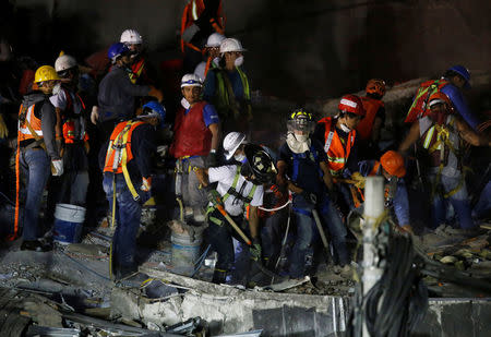 Members of rescue teams search for survivors in the rubble of a collapsed building after an earthquake in Mexico City, Mexico September 23, 2017. REUTERS/Henry Romero