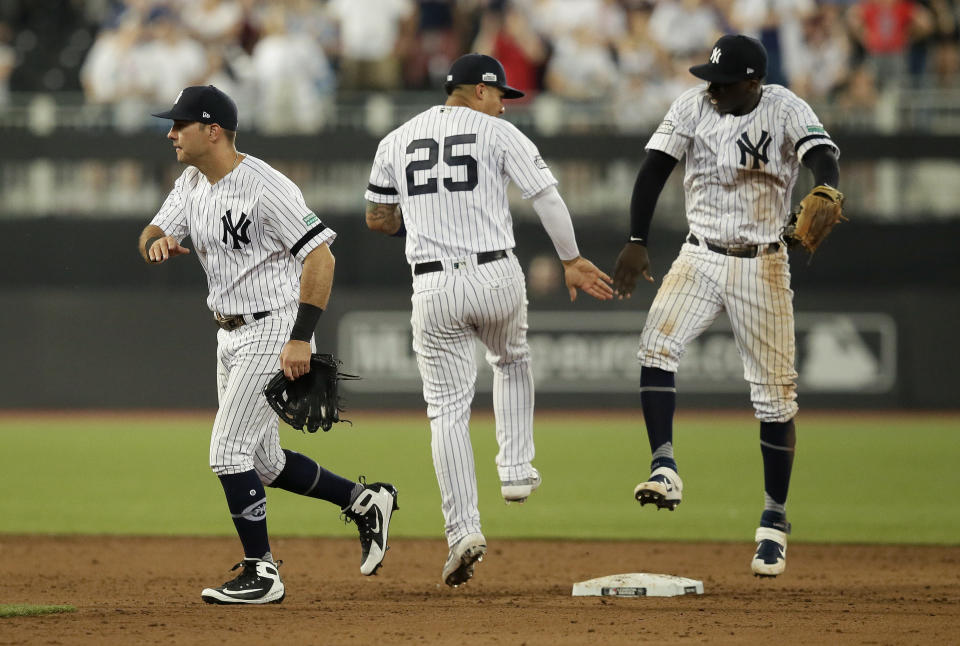 From left, New York Yankees' DJ LeMahieu, Gleyber Torres and Didi Gregorius celebrate after defeating the Boston Red Sox in a baseball game, Saturday, June 29, 2019, in London. Major League Baseball made its European debut game Saturday at London Stadium. (AP Photo/Tim Ireland)