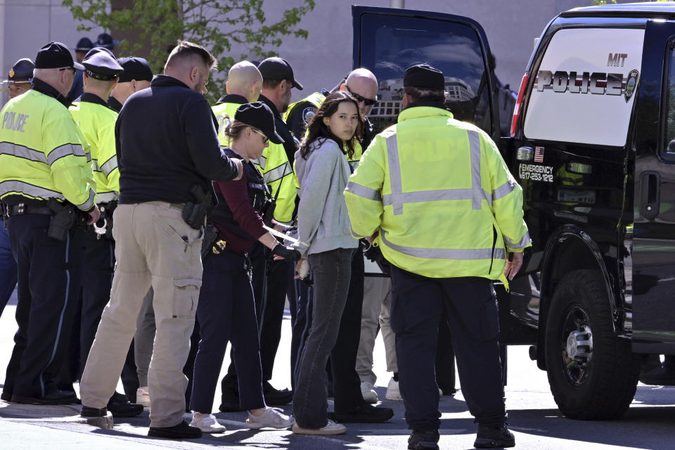 Police detain a pro-Palestinian demonstrator who attempted to block traffic from the garage of the Stata Center at MIT, Thursday, May 9, 2024, in Cambridge, Mass. (AP Photo/Josh Reynolds)