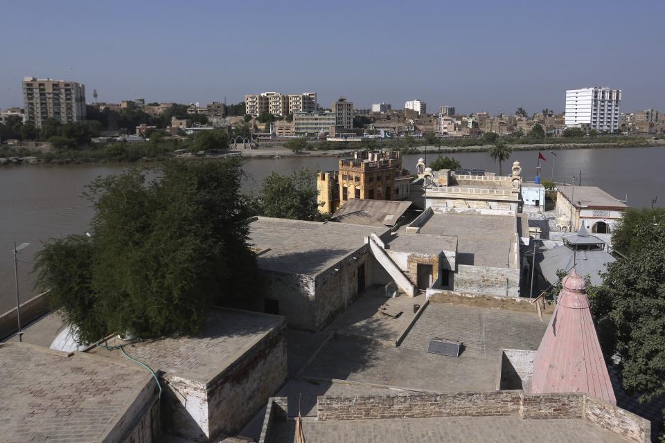 A rooftop view of the Sadhu Bela temple, located in an island on the Indus River, in Sukkur, Pakistan, Wednesday, Oct. 26, 2022. On the banks of the Indus River, which flows through Pakistan and into its southern Sindh province, Hindus wait for brightly colored boats to ferry them to an island that has housed Sadhu Bela temple for almost 200 years. The island was gifted to the Hindu community by wealthy Muslim landlords in Sindh, an unthinkable act in modern-day Pakistan. (AP Photo/Fareed Khan)