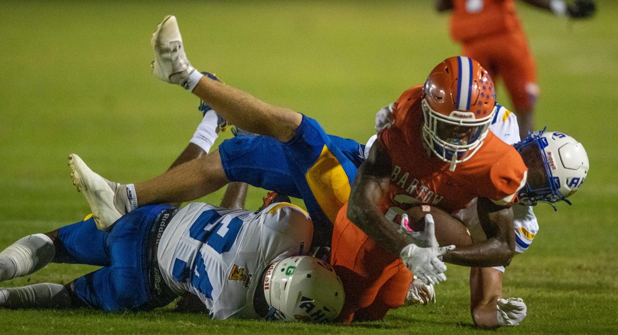 Bartow (2) Trequan Jones dives through Auburndale defenders in first half action at Bartow High School In Bartow Fl. Friday September23,2022Ernst Peters/.The Ledger