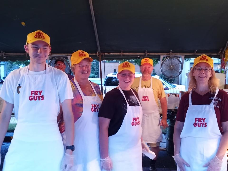 "The Fry Guys" operate the french fry booth at the St. Joseph Festival in Dover.
