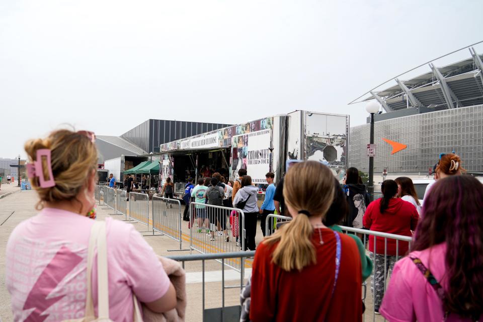 At about 10 a.m., fans approach the trailer to purchase Taylor Swift’s official merchandise from her Eras Tour on Thursday, June 29, 2023, outside Paycor Stadium in Cincinnati.