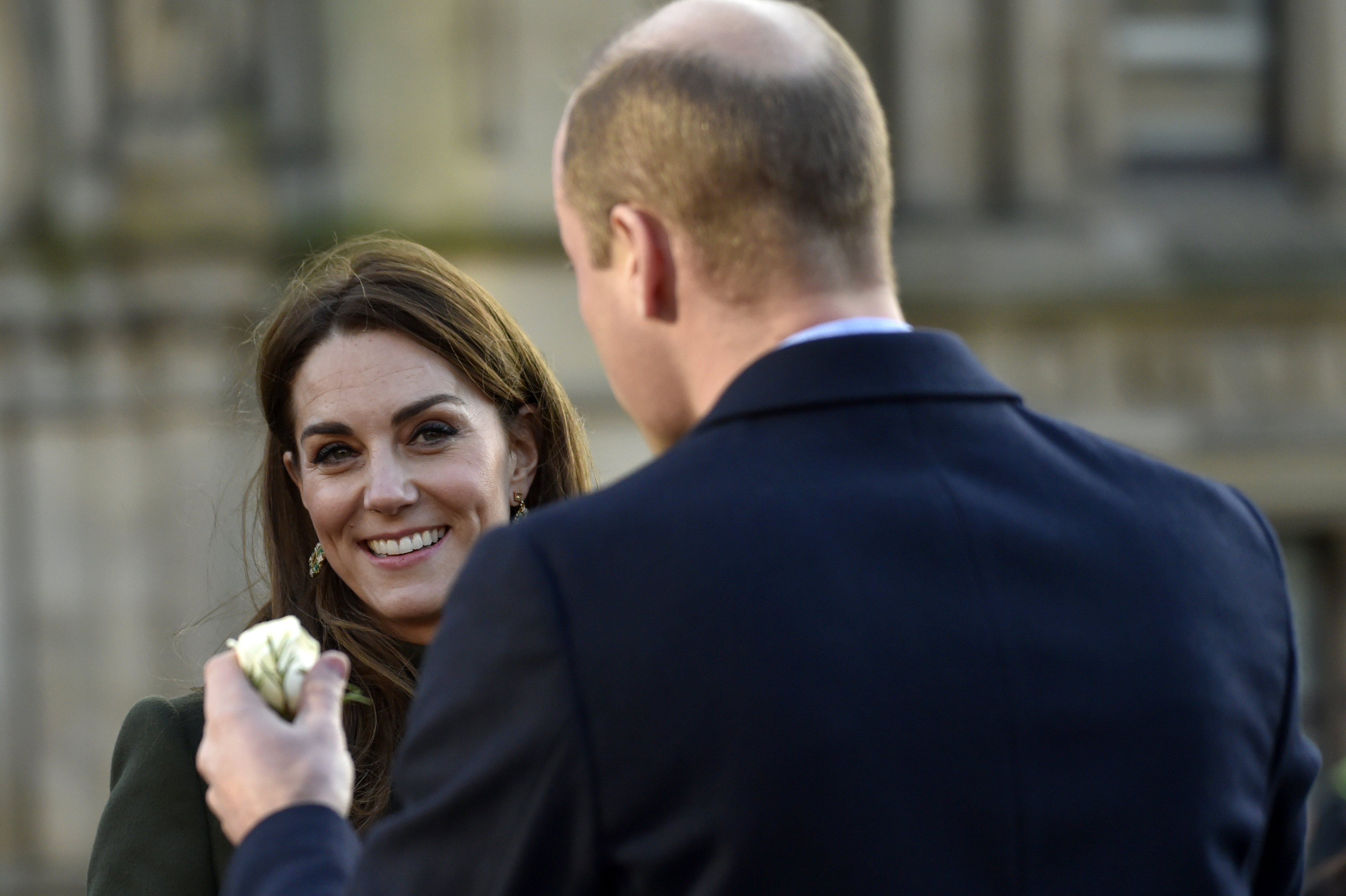 Kate Duchess of Cambridge smiles as Britain's Prince William holds a rose during their meeting with the members of the public at Centenary Square in Bradford northern England, Wednesday, Jan. 15, 2020. (AP Photo/Rui Vieira)