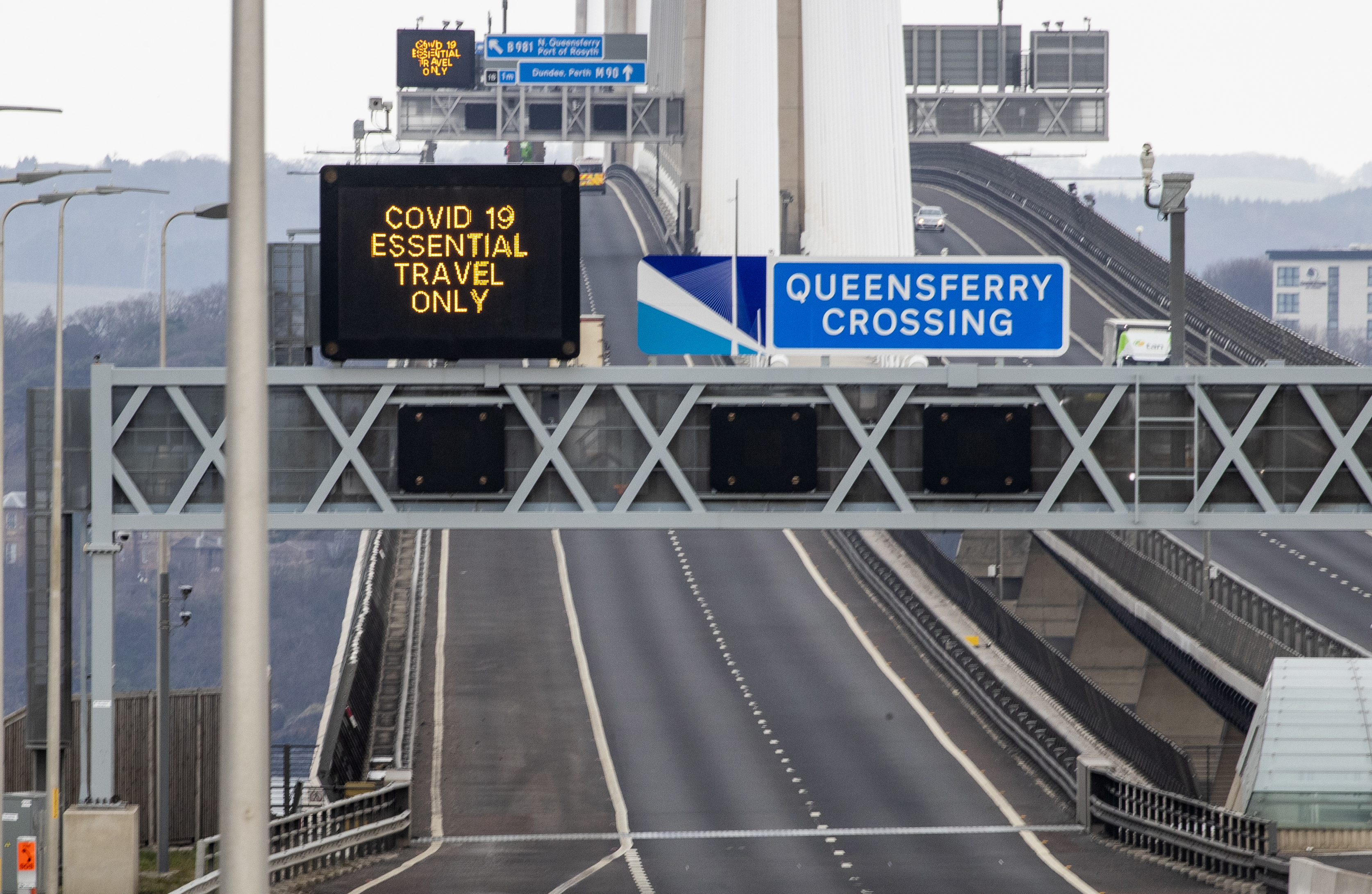 Information signs advise people to take essential travel only on the Queensferry Crossing, near Edinburgh, after Prime Minister Boris Johnson has put the UK in lockdown to help curb the spread of the coronavirus.