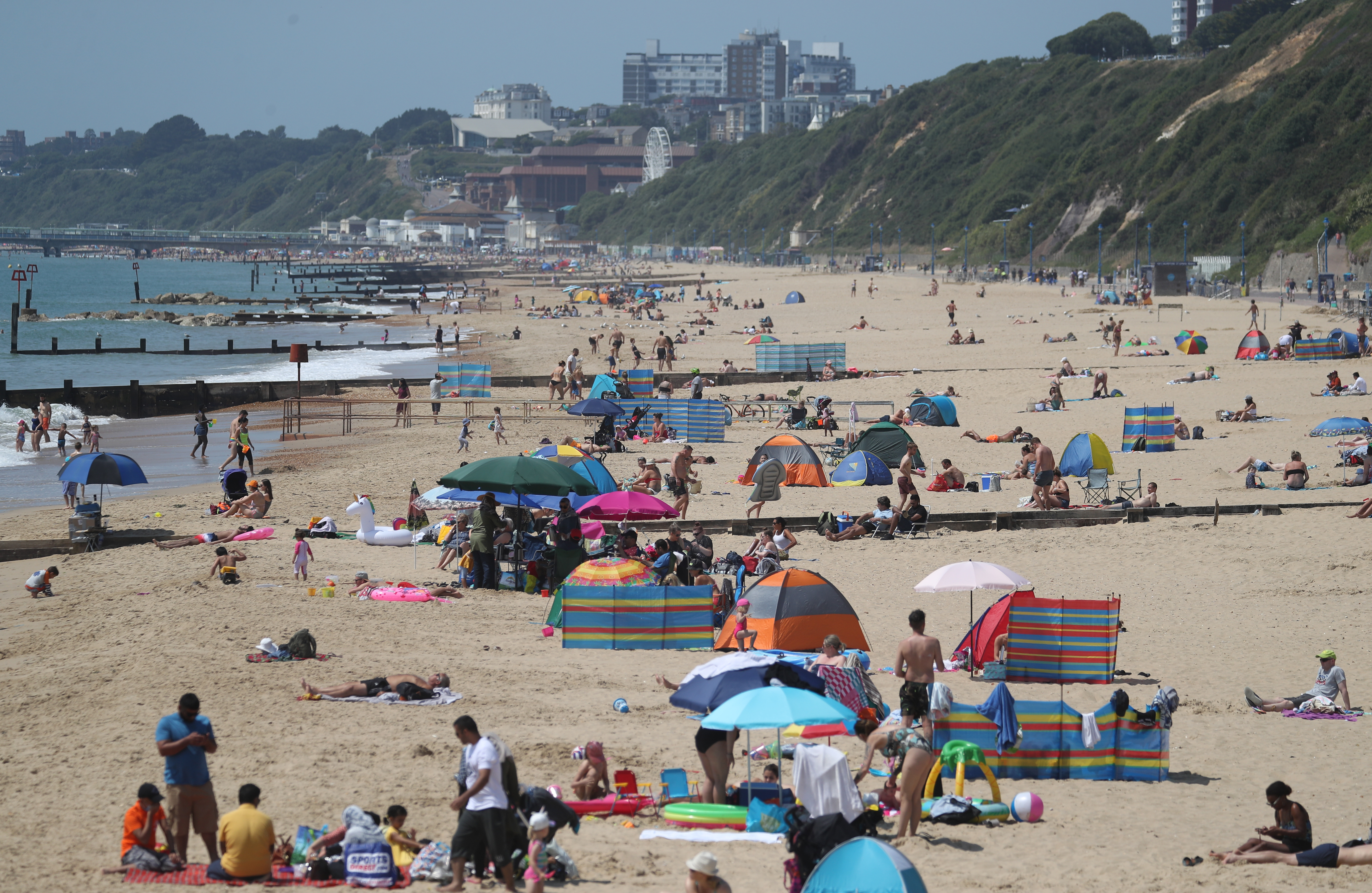 People visit the beach in Boscombe, as Britain is braced for a June heatwave as temperatures are set to climb into the mid-30s this week. (Photo by Andrew Matthews/PA Images via Getty Images)
