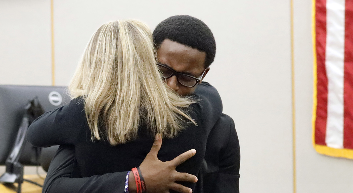 Tears flow as victim's brother hugs sentenced cop