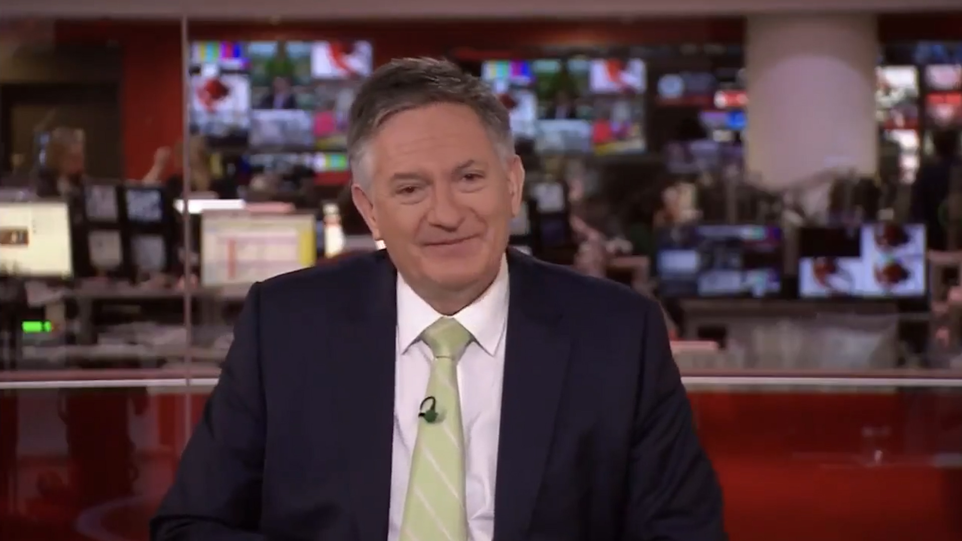 BBC newsreader, Simon McCoy laughs during live news broadcast about a ...