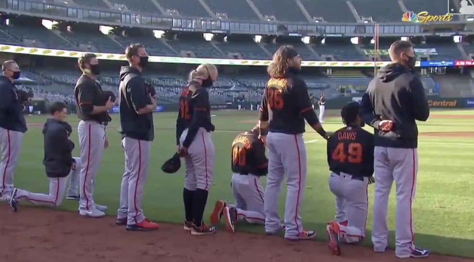 Giants Jewish manager Gabe Kapler kneels during playing of national anthem