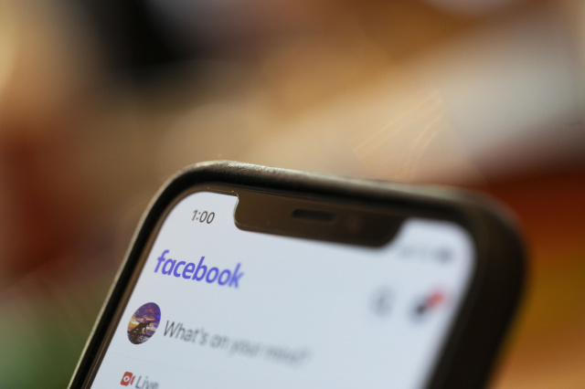 In this Sunday, Aug. 11, 2019, photo an iPhone displays a Facebook page in New Orleans. Facebook says it paid contractors to transcribe audio clips from users of its Messenger service. (AP Photo/Jenny Kane)