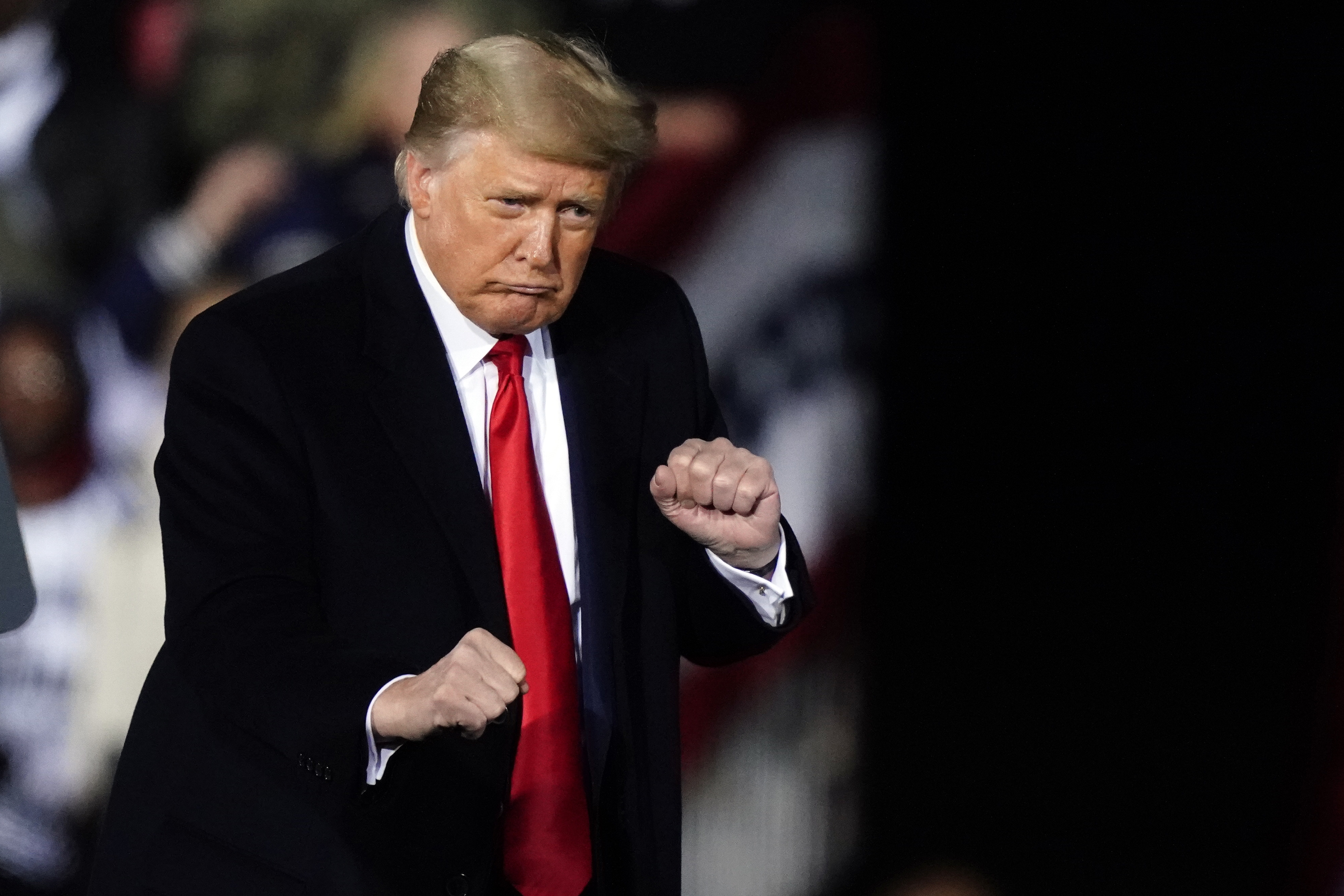 President Donald Trump dances after speaking at a campaign rally in support of Senate candidates Sen. Kelly Loeffler, R-Ga., and David Perdue in Dalton, Ga., Monday, Jan. 4, 2021. (AP Photo/Brynn Anderson)