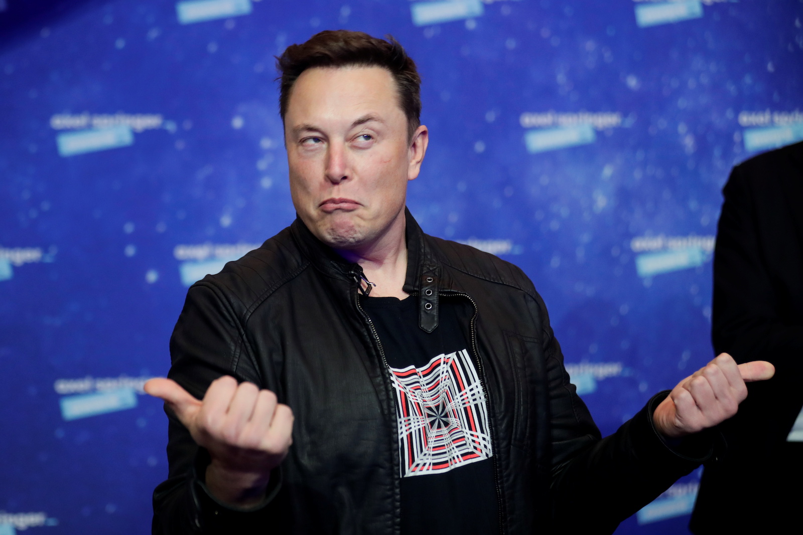 SpaceX owner and Tesla CEO Elon Musk grimaces after arriving on the red carpet for the Axel Springer award, in Berlin, Germany, December 1, 2020. REUTERS/Hannibal Hanschke/Pool - RC2IEK94IOGV