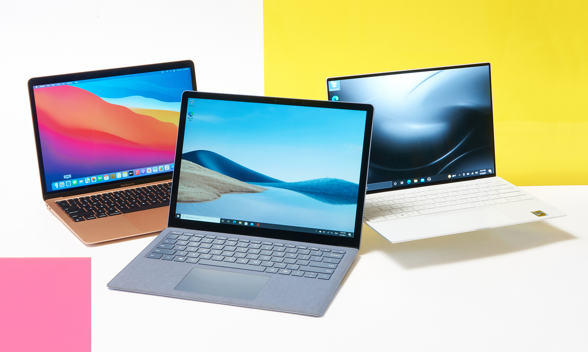 Three laptops against a bright colorful background.