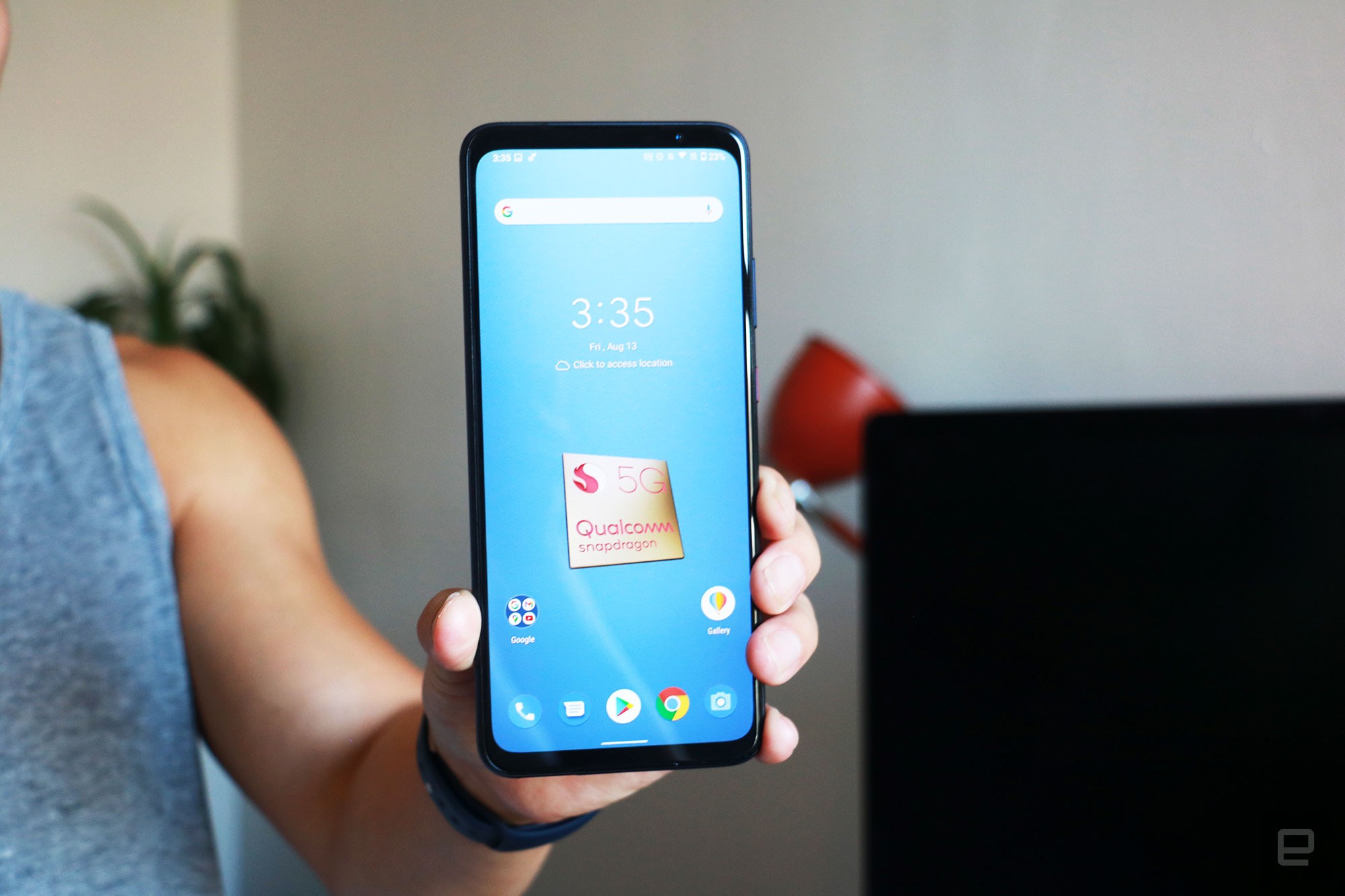 A man holding the Smartphone for Snapdragon Insiders with its screen facing out. 