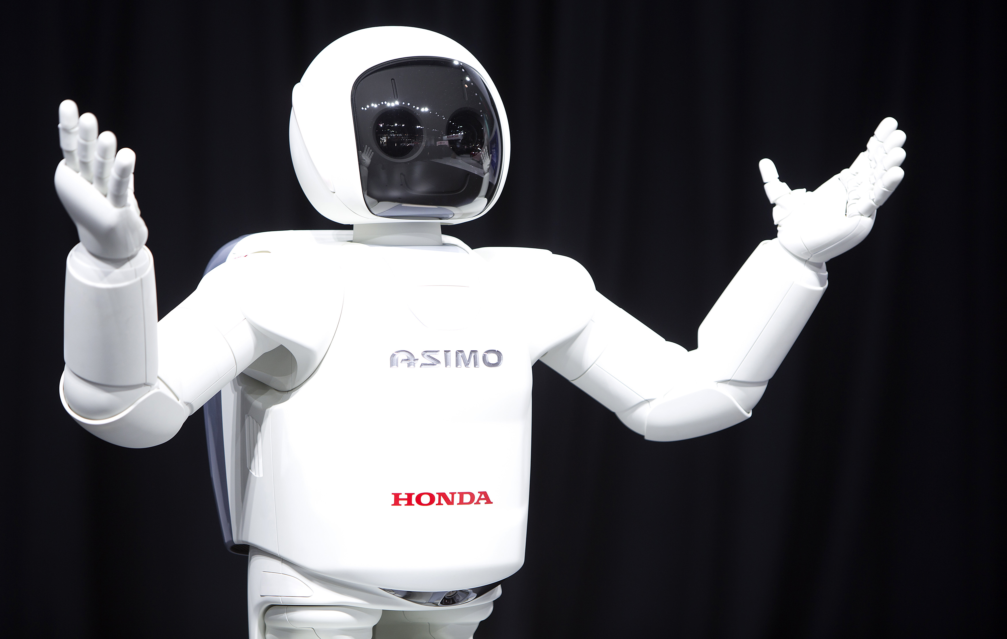 Honda Motor's Asimo robot puts on a demonstration for the media at the Jacob Javits Convention Center during the New York International Auto Show in New York April 17, 2014. REUTERS/Carlo Allegri (UNITED STATES - Tags: TRANSPORT BUSINESS)