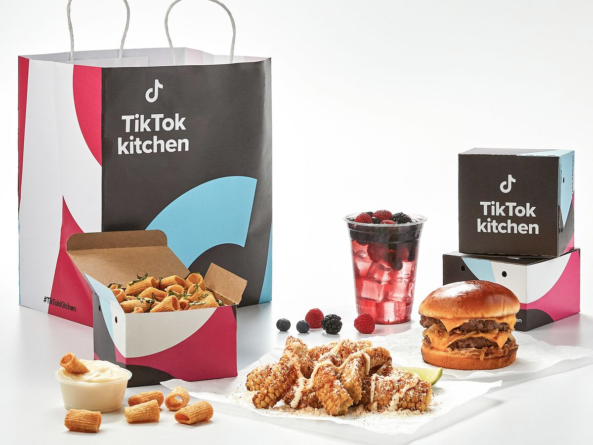 A promo image for TikTok Kitchen, featuring dishes including baked feta pasta. 