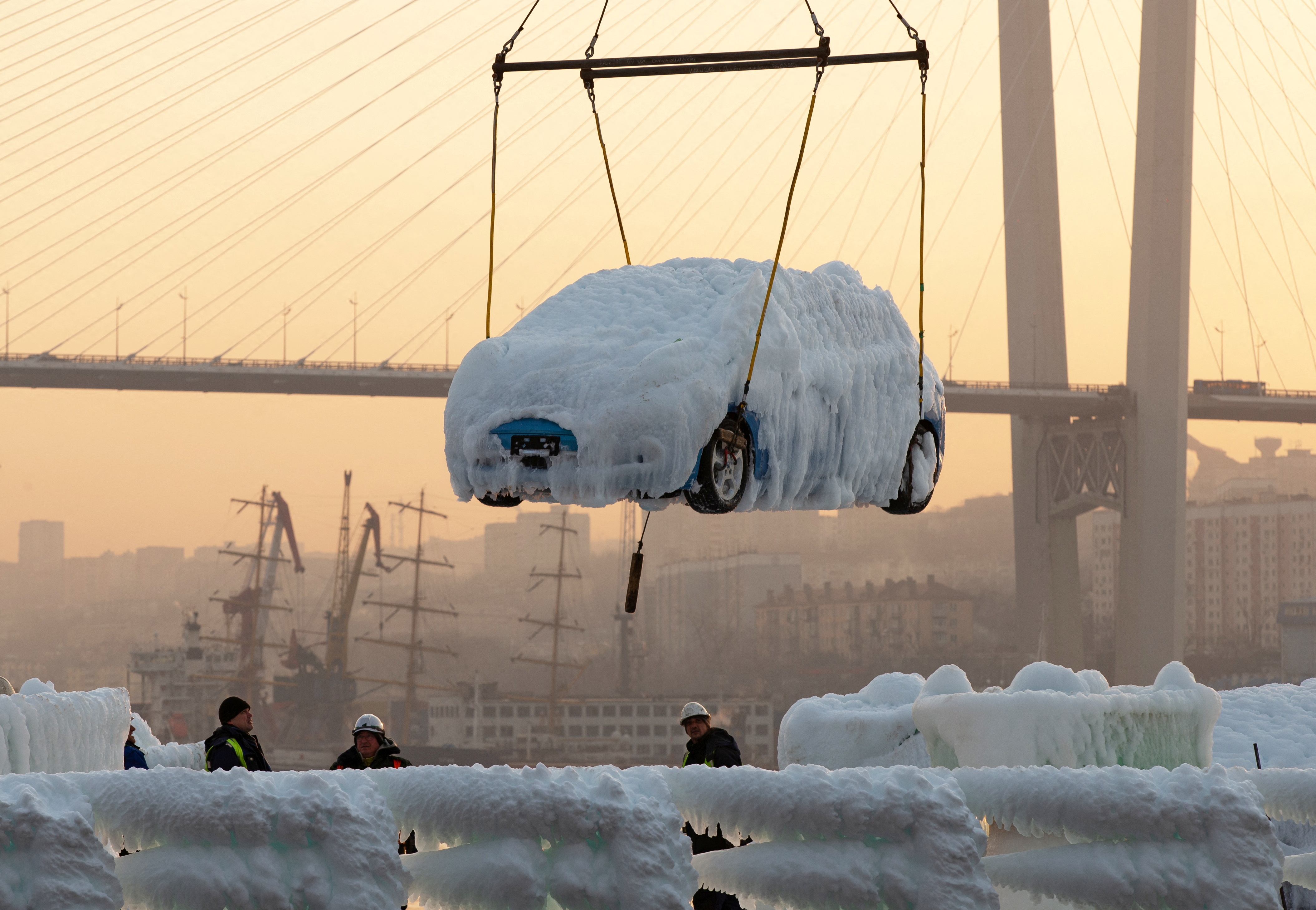 An ice-covered vehicle is unloaded from the cargo ship Sun Rio, which was caught in severe weather conditions in the Sea of Japan, in the port of Vladivostok, Russia December 29, 2021. REUTERS/Tatiana Meel