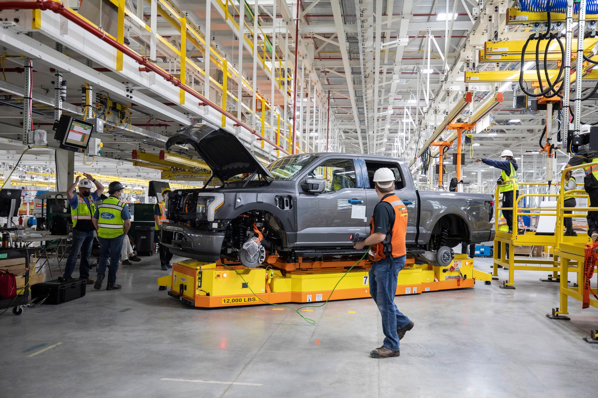 One year after Ford confirmed construction of the Rouge Electric Vehicle Center in Dearborn, Mich., the first Ford F-150 Lightning pre-production units begin leaving the factory. Pre-production model shown. F-150 Lightning available starting spring 2022.