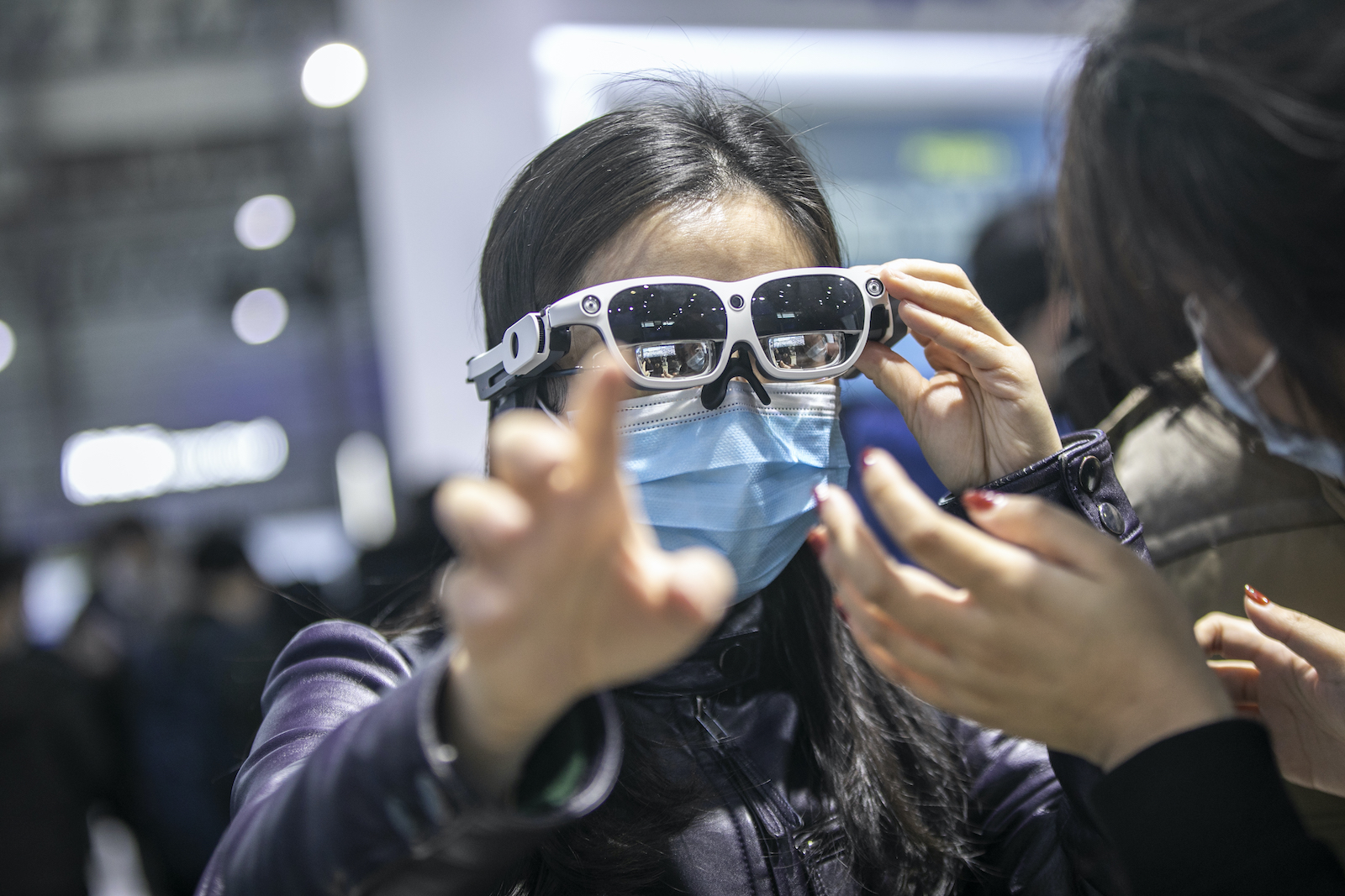 SHANGHAI, CHINA - FEBRUARY 24: A visitor tries out a pair of augmented reality (AR) glasses at the Qualcomm booth during the Mobile World Congress (NWC) Shanghai 2021 at Shanghai New International Expo Center on February 24, 2021 in Shanghai, China. (Photo VCG/VCG via Getty Images)