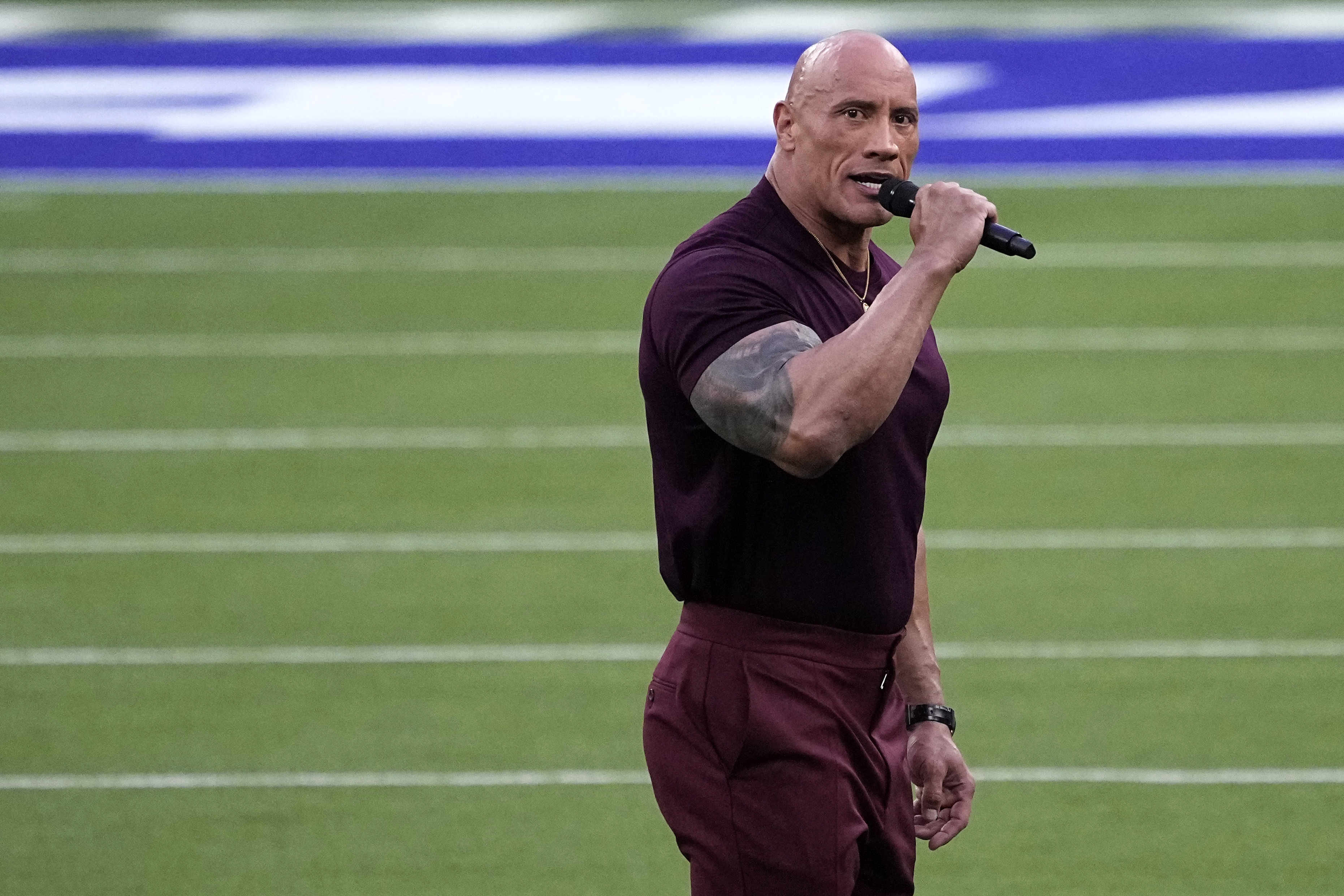 Actor Dwayne Johnson announces the start of the NFL Super Bowl 56 football game between the Cincinnati Bengals and the Los Angeles Rams, Sunday, Feb. 13, 2022, in Inglewood, Calif. (AP Photo/Elaine Thompson)