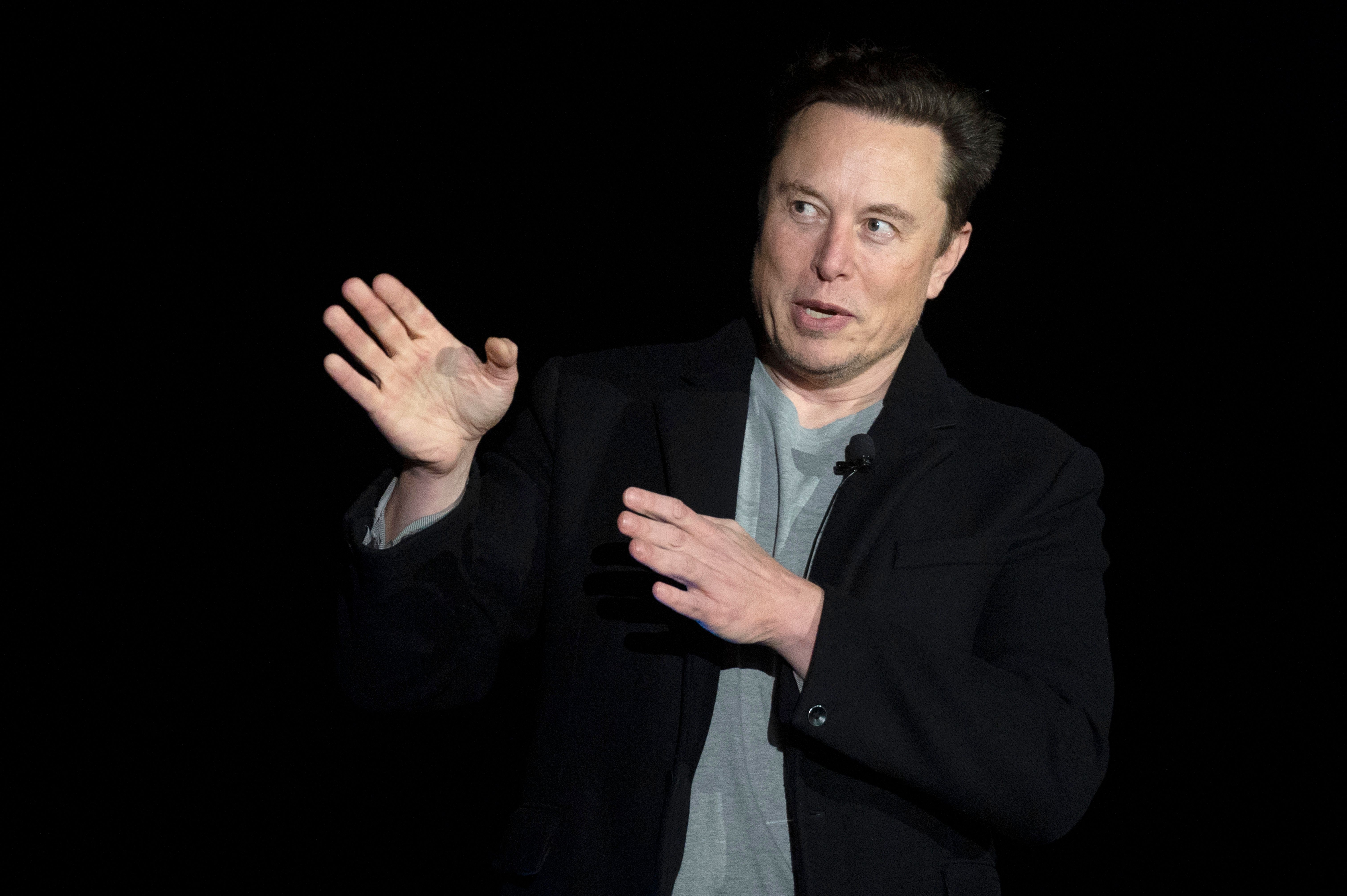 Elon Musk gestures as he speaks during a press conference at SpaceX's Starbase facility near Boca Chica Village in South Texas on February 10, 2022. - Billionaire entrepreneur Elon Musk delivered an eagerly-awaited update on SpaceX's Starship, a prototype rocket the company is developing for crewed interplanetary exploration. (Photo by JIM WATSON / AFP) (Photo by JIM WATSON/AFP via Getty Images)