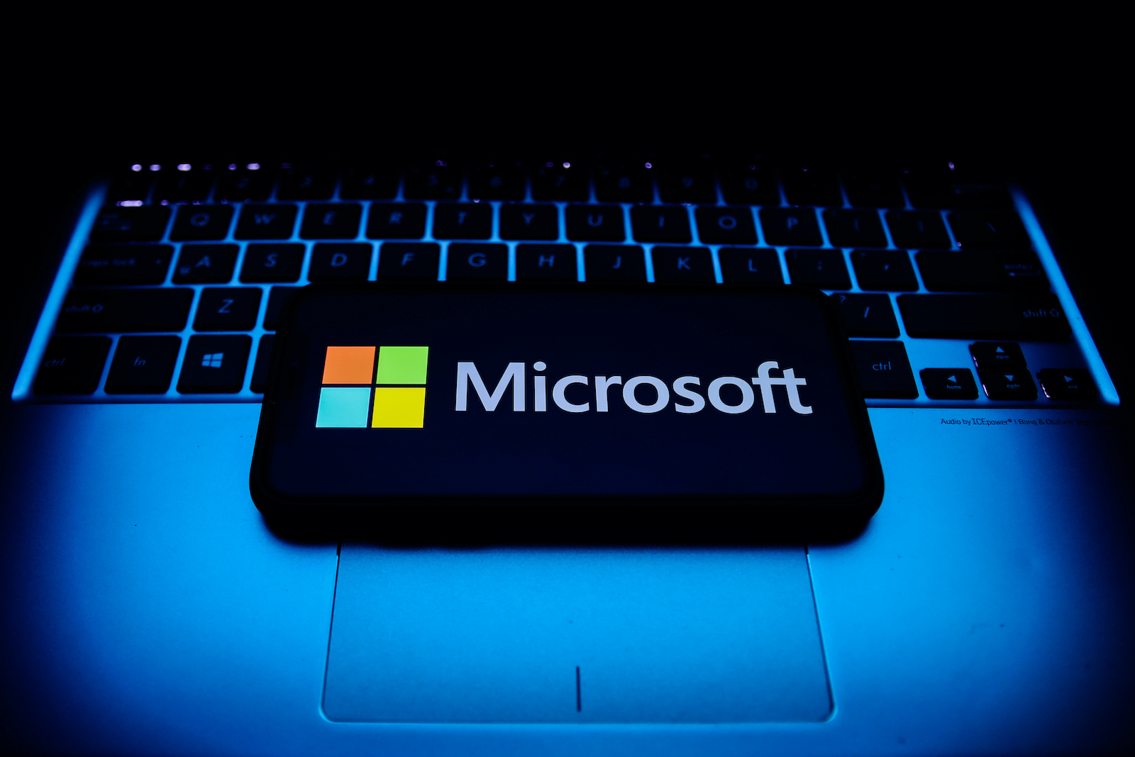 Microsoft logo displayed on a phone screen and a laptop keyboard are seen in this illustration photo taken in Krakow, Poland on October 30, 2021. (Photo by Jakub Porzycki/NurPhoto via Getty Images)