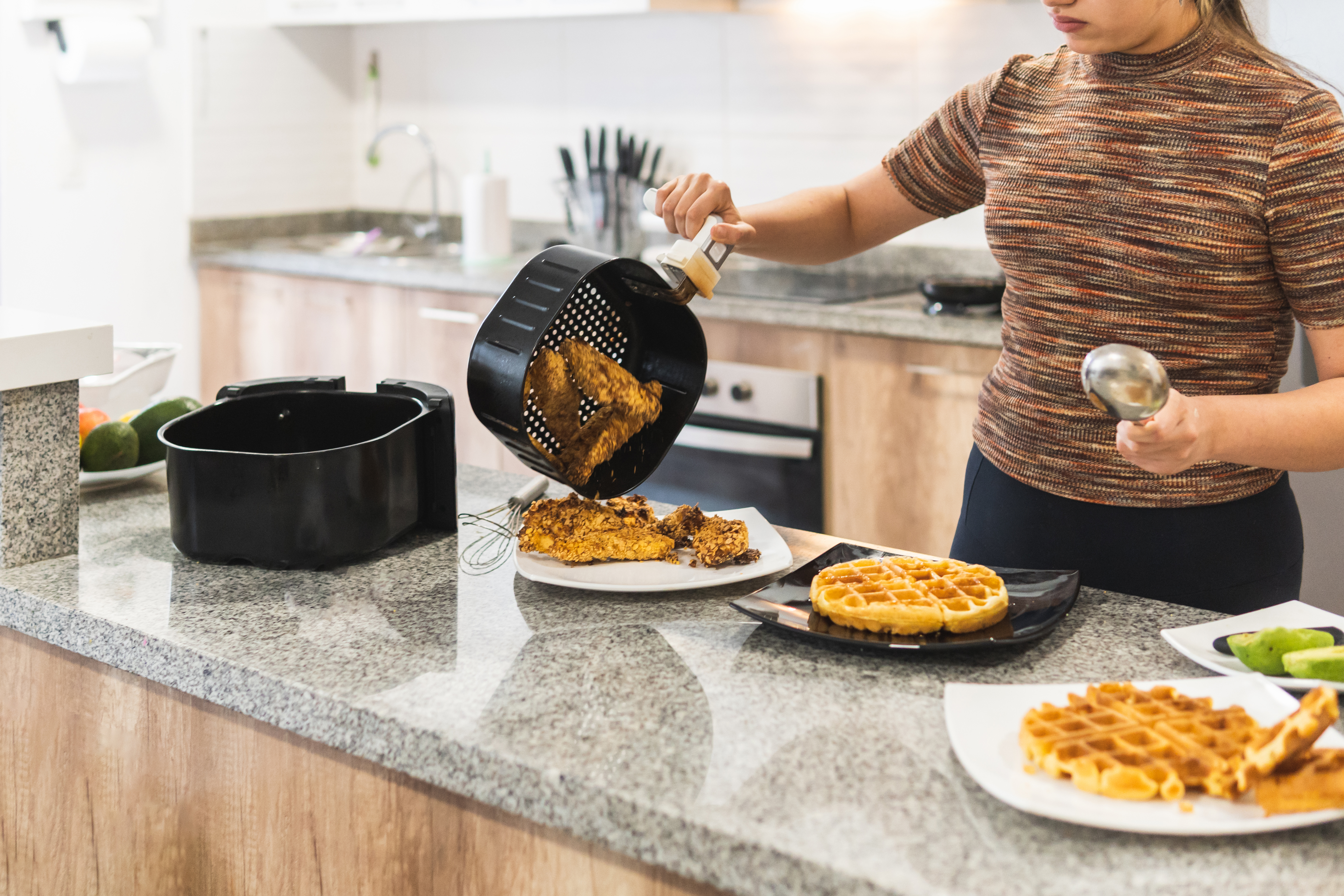 woman serving fried chicken with air fryer waffles