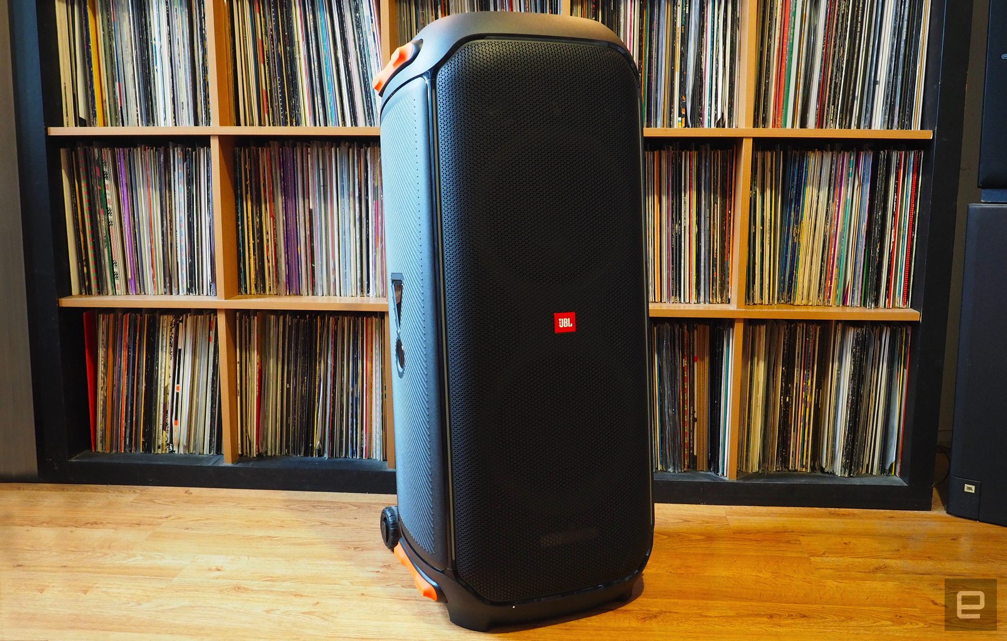 The JBL PartyBox 710 photographed for Engadget's 2022 portable Bluetooth speaker guide in front of a shelf full of records.