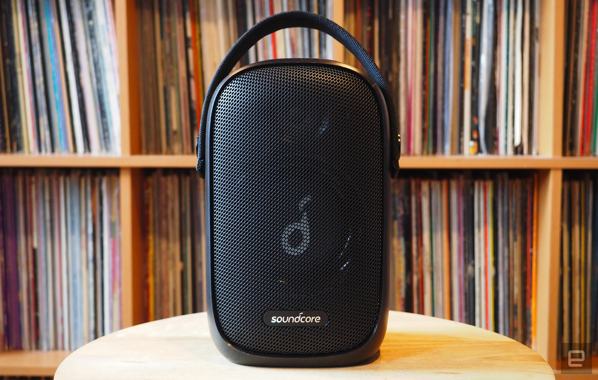 The Soundcore Trance Go photographed for Engadget's 2022 portable Bluetooth speaker guide in front of a shelf full of records.