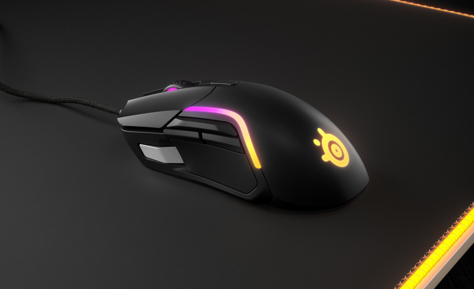 The black SteelSeries Rival 5 gaming mouse on a black mousepad.
