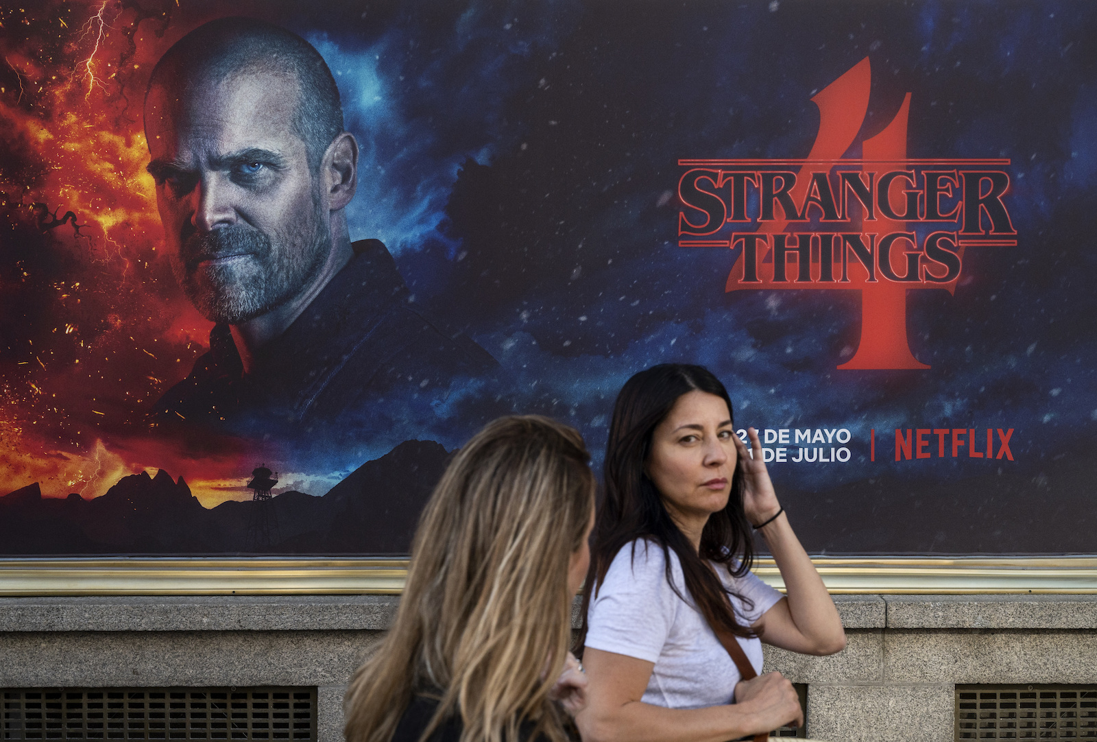 MADRID, SPAIN - 2022/05/27: Pedestrians walk past a street commercial advertisement banner from the American global on-demand Internet streaming media provider Netflix featuring Stranger Things Season 4 TV show in Spain. (Photo by Xavi Lopez/SOPA Images/LightRocket via Getty Images)
