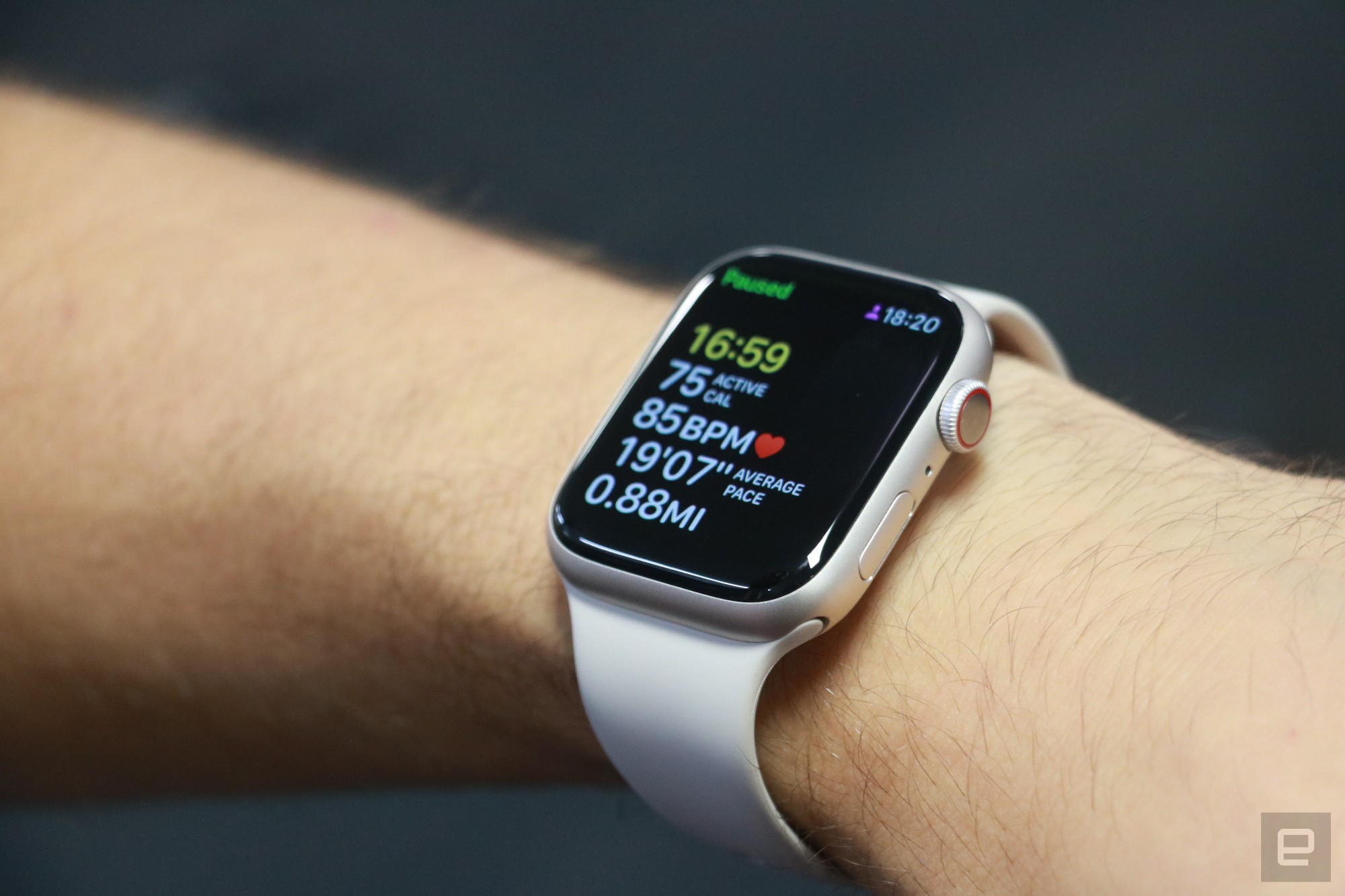 The Apple Watch Series 8 on a person's wrist, showing a paused workout tracking screen.