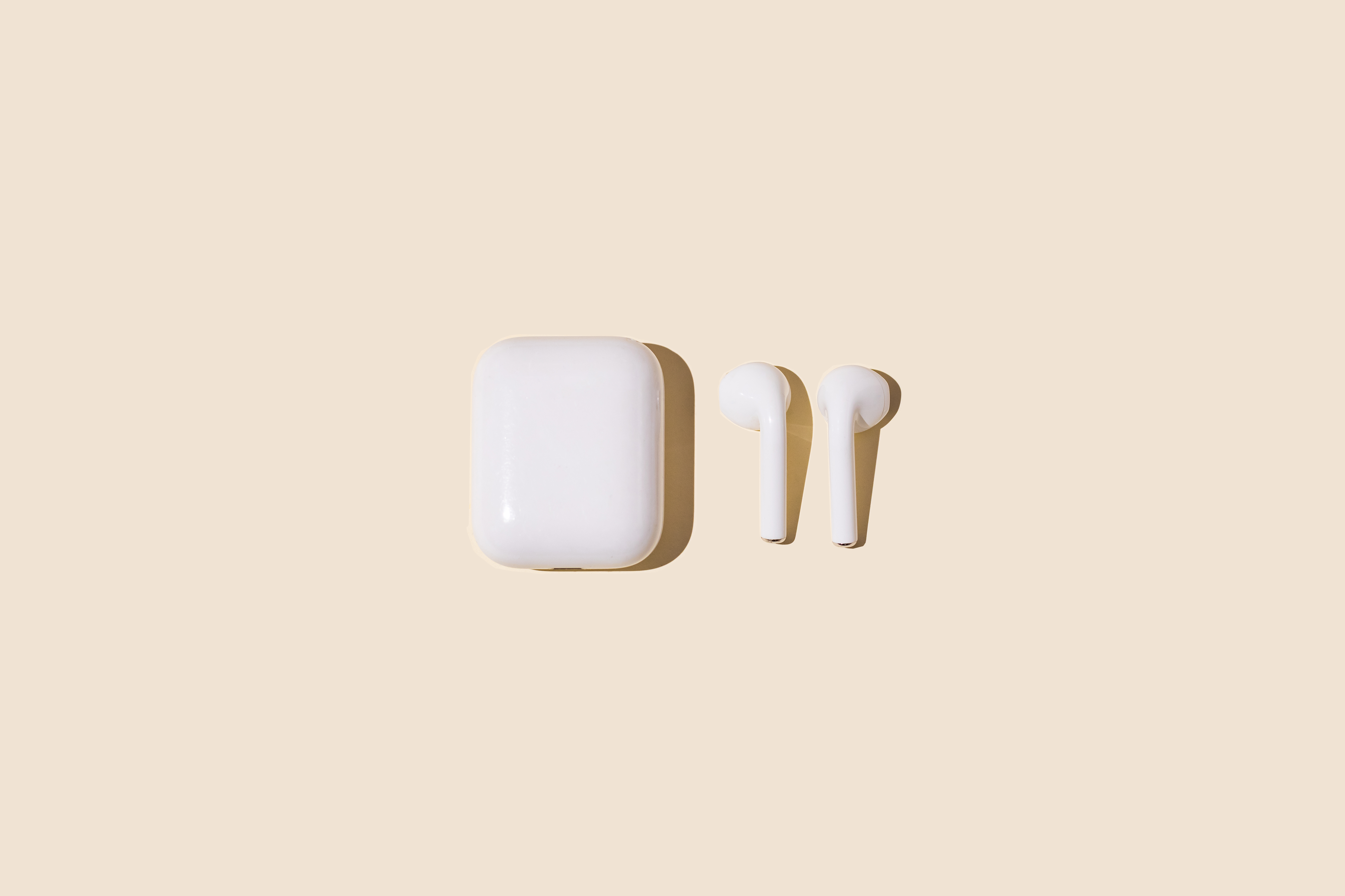 Wireless white headphones on yellow pastel background." data-uuid="7a491c3f-5405-3a6f-ad97-78a063986758