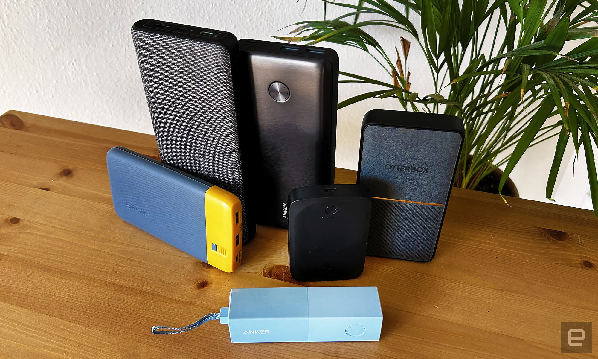 The six winning power banks arranged on a wooden table with a houseplant in the background " data-uuid="6d695920-f41f-318a-959b-2c69a55bb3d2