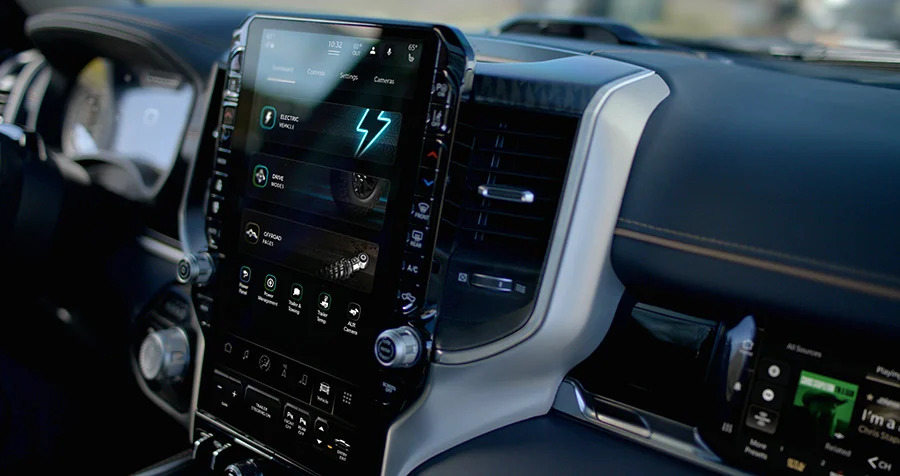 An interior shot of the RAM 1500 Rev, showing off the truck's large infotainment unit. 