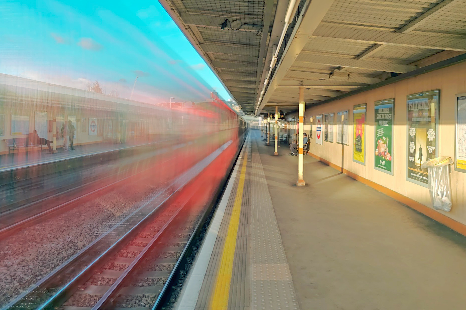 A photo of a blurred underground train running through a station.