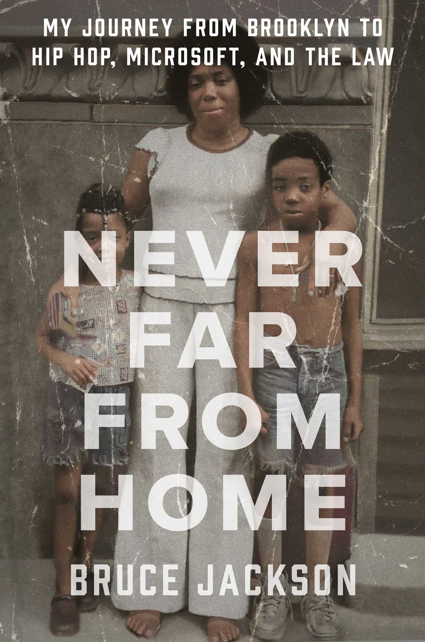 background is full-fill of a creased picture of a black woman standing in front of a grey wall, each of her arms draped around the shoulders of two boys (elementary school aged). Looks like a family snapshot taken in the late 70s/early 80s. Title and author name in all caps white lettering atop. 