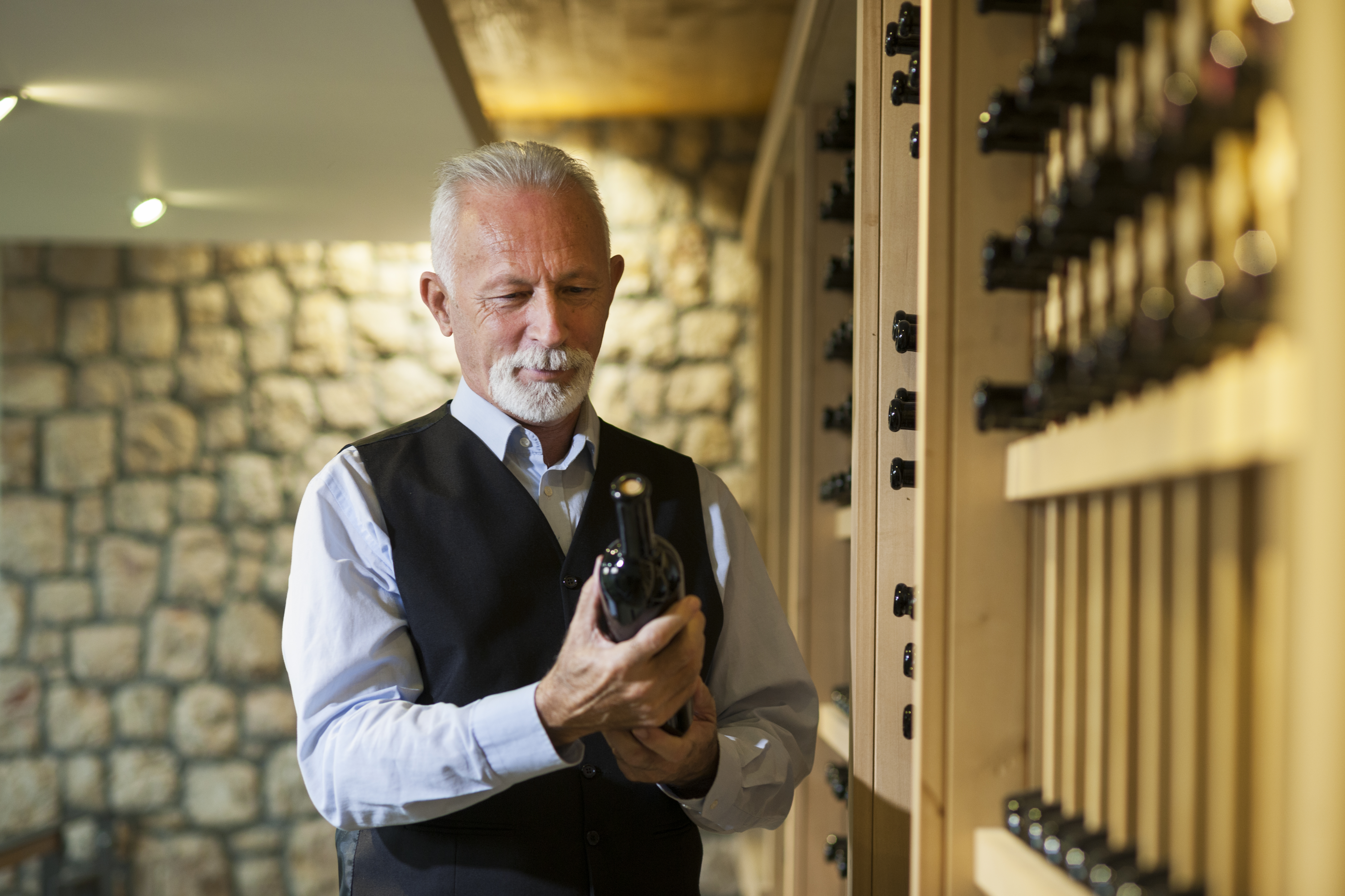 Senior winemaker with his collection of wine