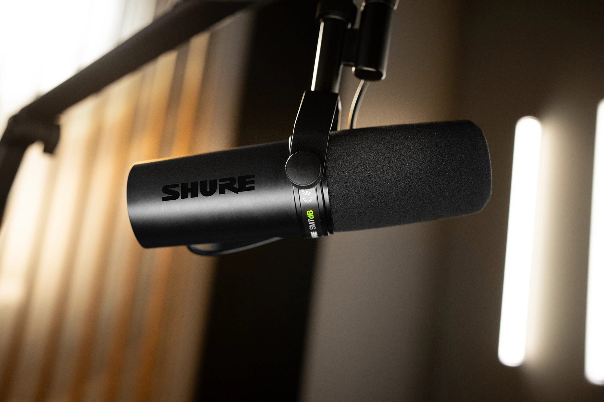 A press photo of the Shure SM7dB shows the microphone hanging from a boom arm.