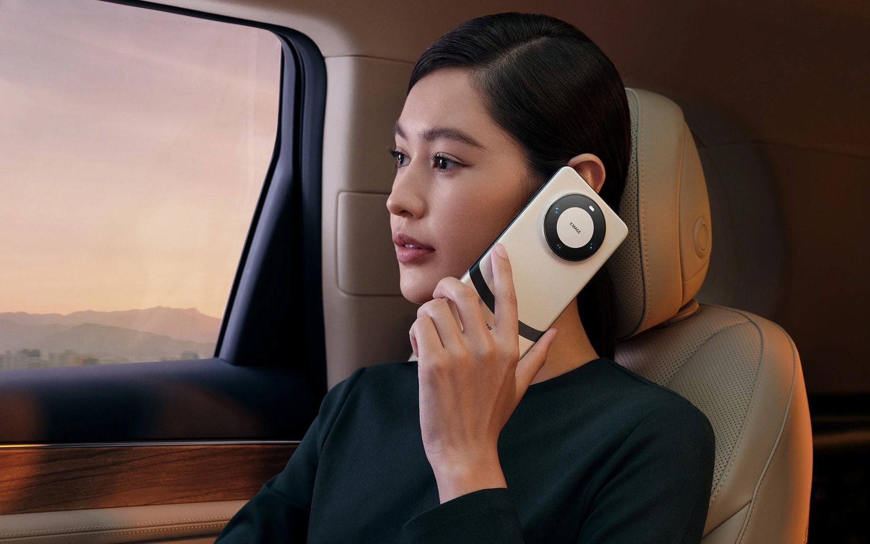 A female model posing with a Huawei Mate 60 Pro+ in a luxury car.