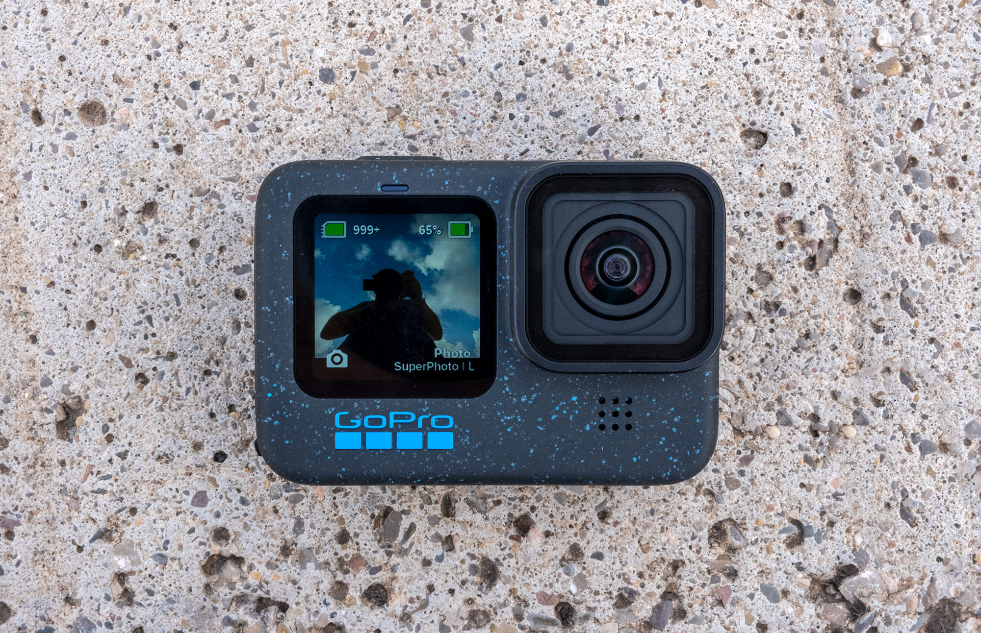 The new GoPro Hero 12 Black is pictured while placed on pavement.