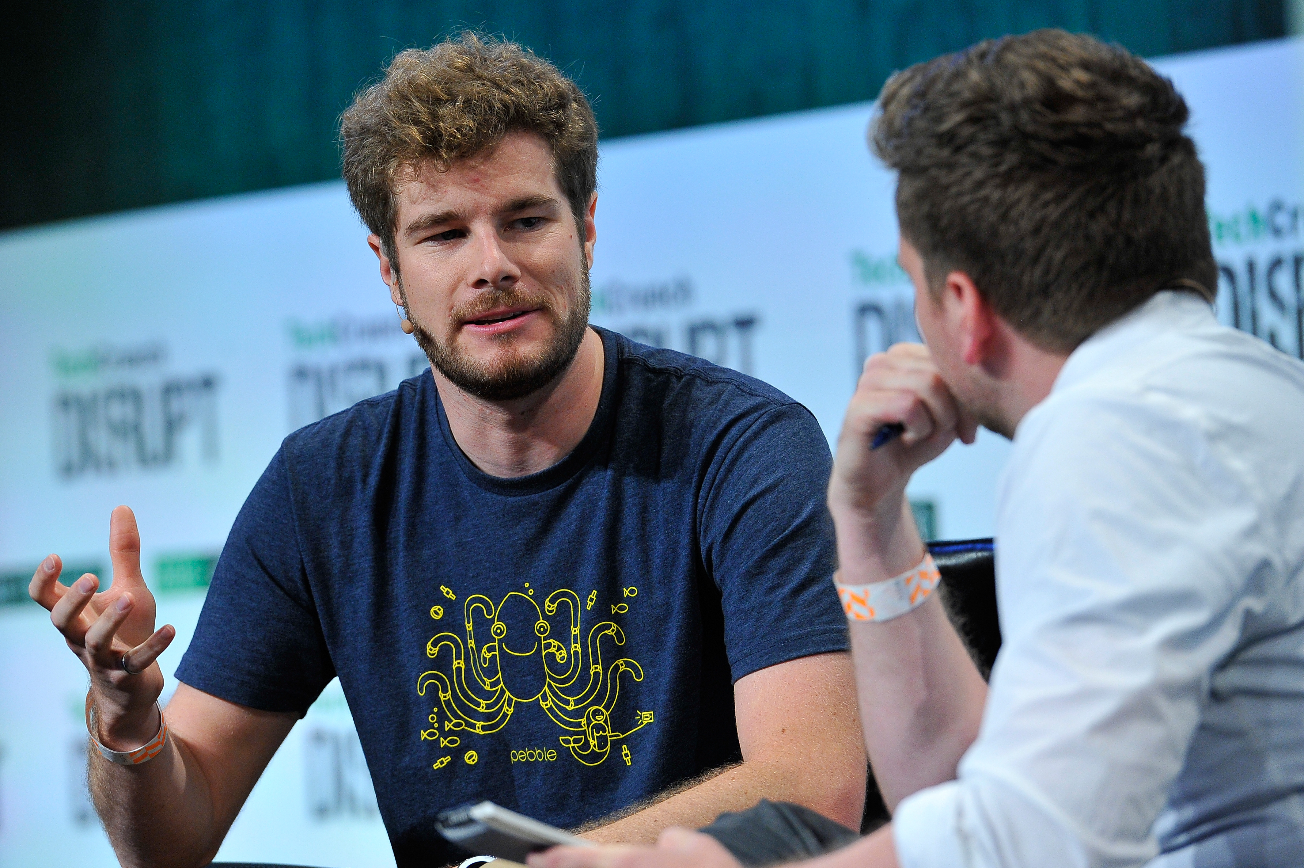 SAN FRANCISCO, CA - SEPTEMBER 23: Moderator Greg Kumparak speaks with Eric Migicovsky of Pebble onstage during TechCrunch Disrupt SF 2015 at Pier 70 on September 23, 2015 in San Francisco, California. (Photo by Steve Jennings/Getty Images for TechCrunch)