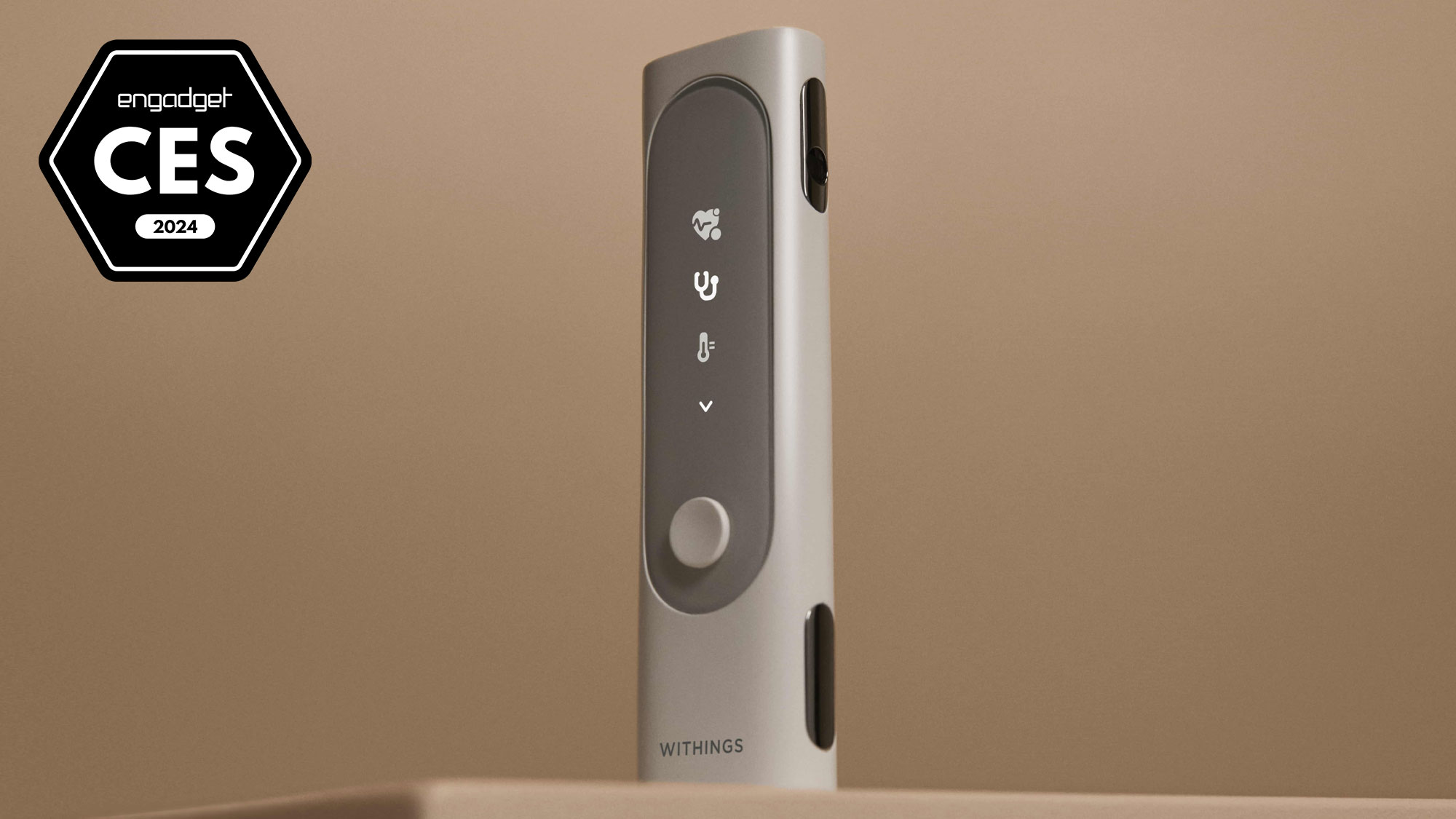 An image with a badge for Engadget Best of CES 2024 showing the product: Withings BeamO device which is similar in shape to a TV remote control standing on its end against a beige background.