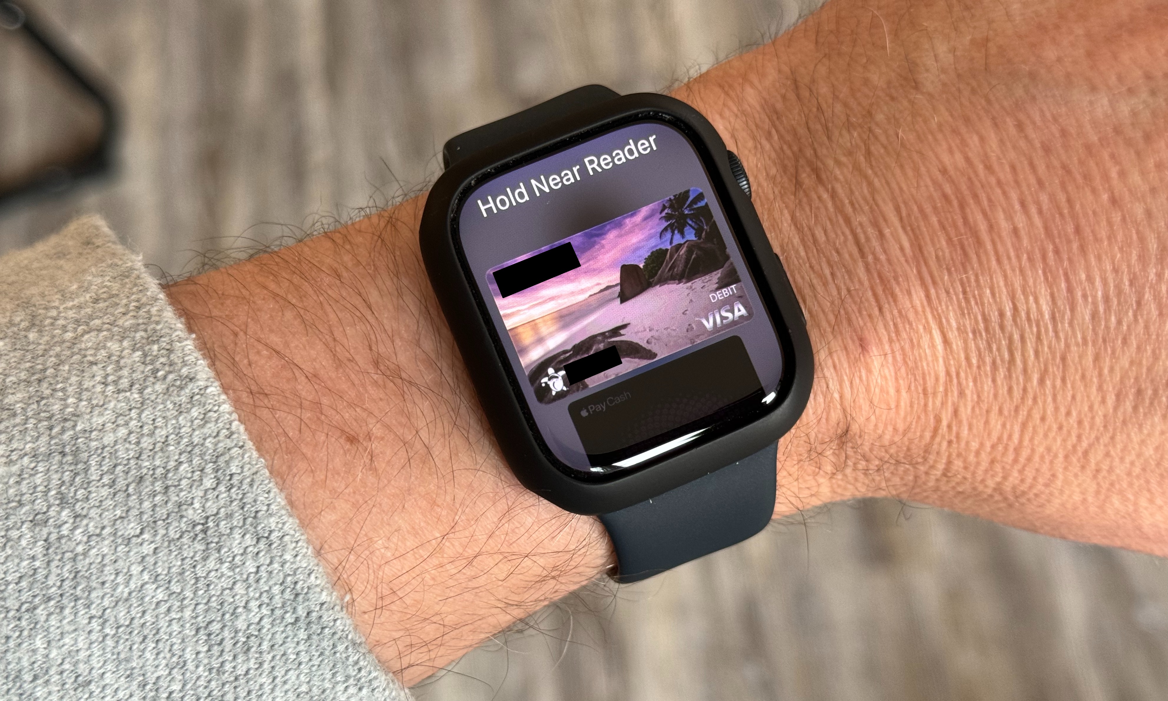 Photo of a man’s wrist wearing an Apple Watch. The Apple Pay screen is on the watch's face. It says 