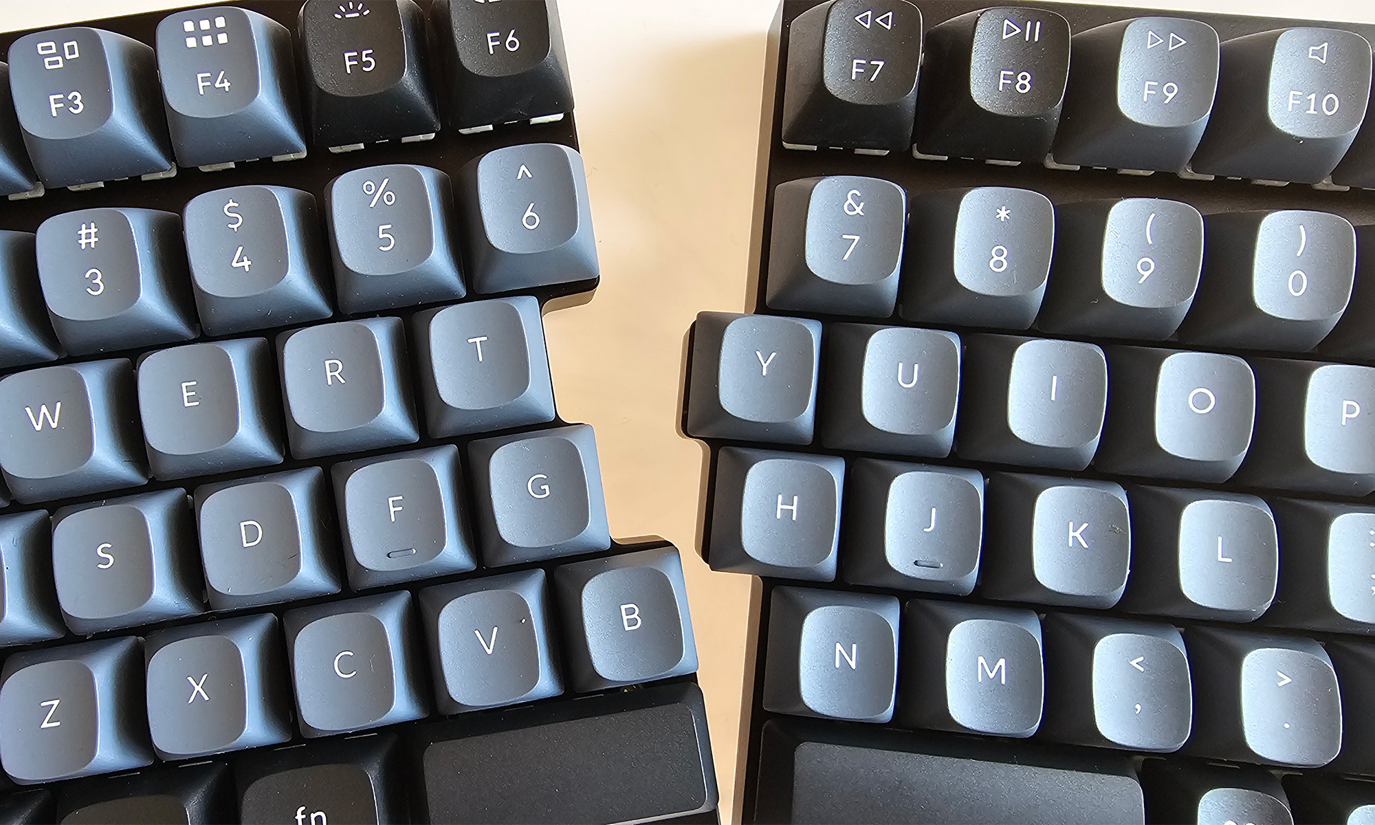 A closeup shot of an ergonomic keyboard that shows the two sides splitting apart. 